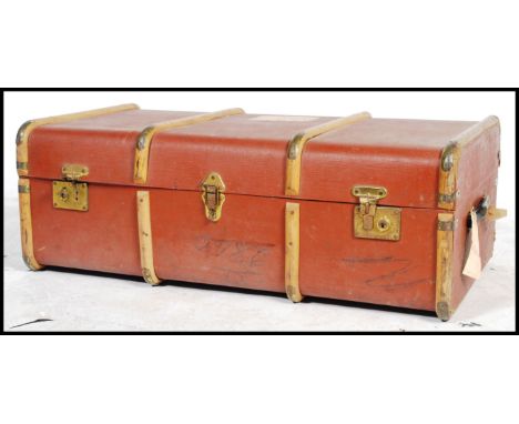 A vintage&nbsp;mid century&nbsp;wooden bound steamer trunk in brown having brass clasps to&nbsp;front.
