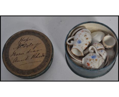 A 19th century Victorian miniature tea service in original circular box with notation to lid. Highest measures 3cm.&nbsp;