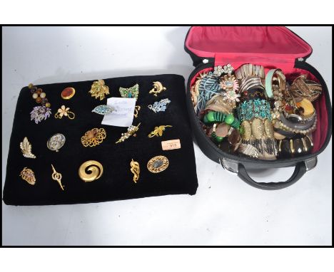 A case of vintage costume dress jewellery along with a group of 20 brooches to include rhinestone , enamel , flower , pictori