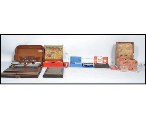 A collection of vintage items to include various cased Gillette and other razors, vintage cribbage board, a boxed set of retr