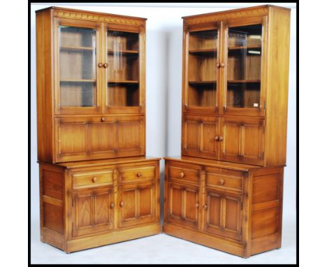 Ercol - Mural -  A pair of glazed window bookcases comprising of a twin glazed bookcase top with a drop down cocktail cabinet