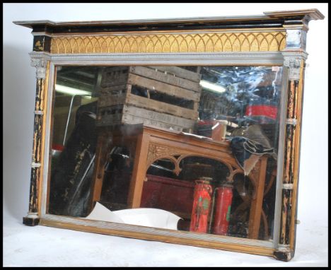 A 19th century large mirror panel held within an ornate Regency style stepped painted wooden frame with scrolled classical de