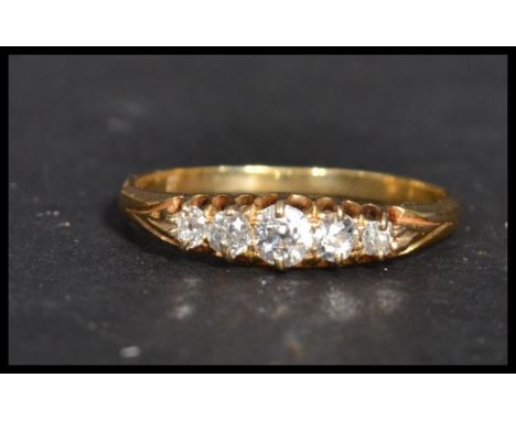 An 18 carat gold three stone diamond ring. Weighs 2.5 grams size R.&nbsp;