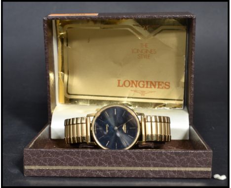 A vintage Longines quartz movement wrist watch complete in the original box. The black enamel face having gilt baton numerals