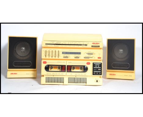 A vintage Bush Radio 1980's white / cream hi-fi stereo system having hinged top record player, radio and twin cassette deck t