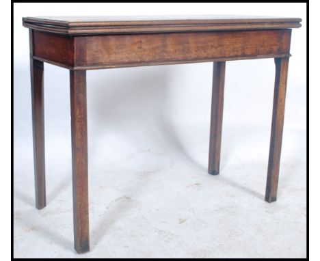 A 19th century Georgian mahogany card - games / tea table being raised on squared legs having a fitted frieze frame with hing