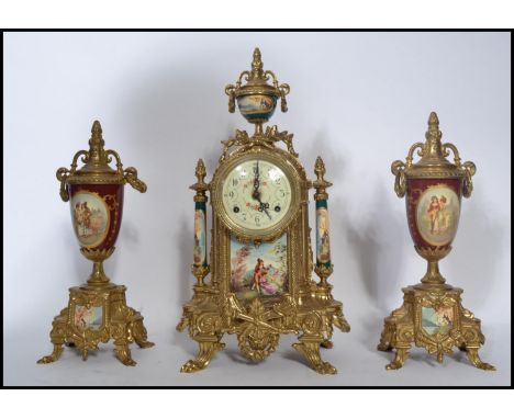 A 19th century German Continental clock and garniture set. The garnature's being of urn form with red ceramic bodies having s