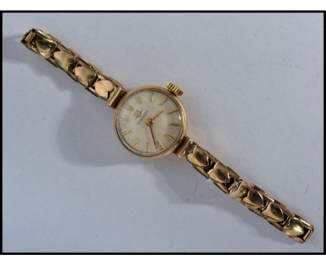 A hallmarked 9ct gold Tissot wristwatch cocktail watch. The silvered dial having baton numerals. Set to the original 9ct gold