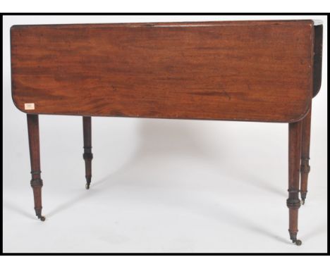 A 19th century mahogany pembroke table being raised on tapering legs with fitted frieze having end drawer. The table top with