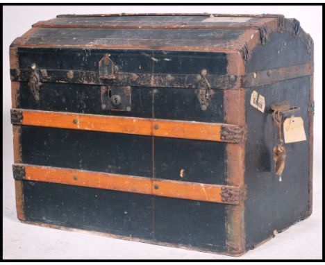A 19th century Victorian dome top trunk having hinged top being ebonised canvas and wooden bound to the exterior