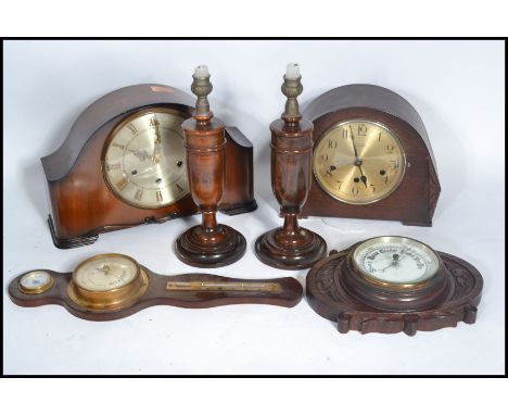 Two vintage early 20th century wooden cased mantel clock along with two vintage barometers and a pair of turned wood candlest