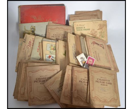 A large collection of vintage 20th century Wills cigarette cards in albums to include Military Uniforms , Tennis , Railway , 