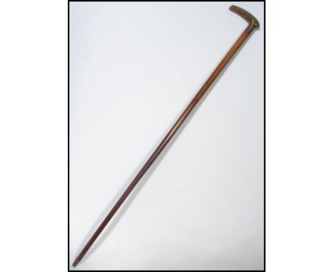 A 19th century Victorian walking stick cane having a tapering wooden shaft with shaped handle. The silver hallmarked collar b