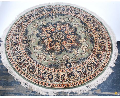 A 20th century Bidjar Persian / Iranian carpet rug of circular form. The rug decorated with geometric patterns and medallions