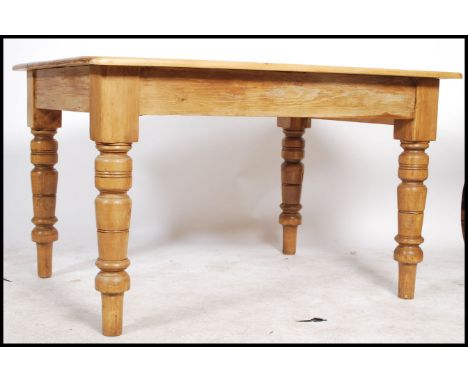 A 20th century pine dining table having a square&nbsp;top and rounded edges, the frieze having a single drawer with knob hand