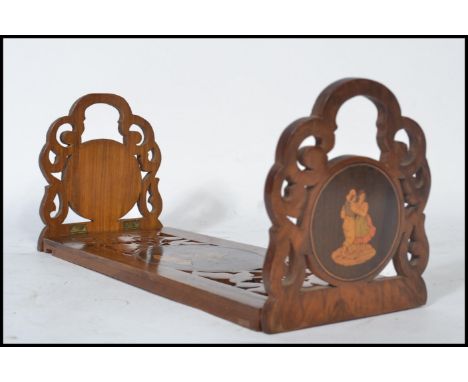 A 19th century olive / fruit wood book trough of metamorphic form. The slide out carved pierced panel and sides having cartou
