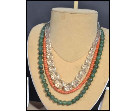 Three vintage 20th century bead necklaces to include a jade example with silver clasp , faceted glass example and a coral rou