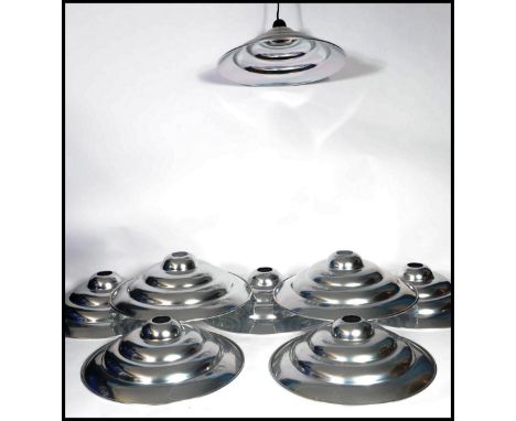 A set of eight vintage 20th century retro ' Space Age ' chrome ceiling pendant UFO type light shades of stepped conical form.