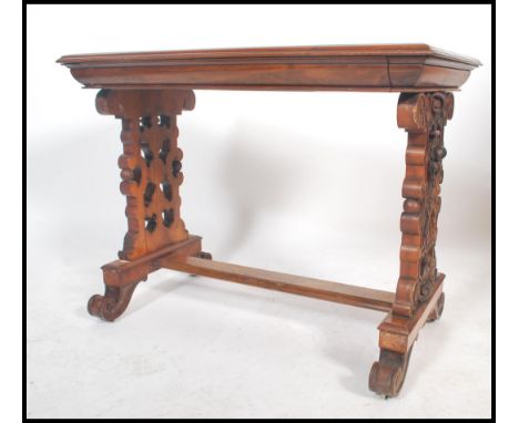 A&nbsp; good 19th century Victorian walnut writing table desk being raised on pierced column supports united by a lower centr