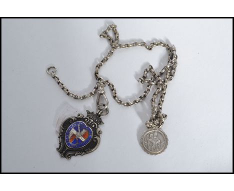 A vintage 20th century silver hallmarked fob medal on a silver chain. The fob medal having enamelling along with a St Christo