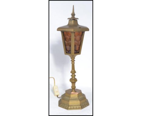 A vintage early 20th century brass lantern raised on a stepped octagonal base with knopped stem. The lantern of hexagonal for