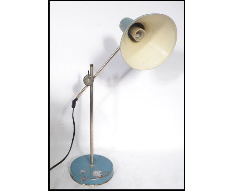 A 1970's Scandinavian vintage industrial teal and chrome desk lamp having a conical two-tone shade on a pivoting arm raised o