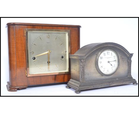 Two early 20th century clocks. One being a wooden cased clock with silvered dial with gilt faceted hands. The dial stamped Pa