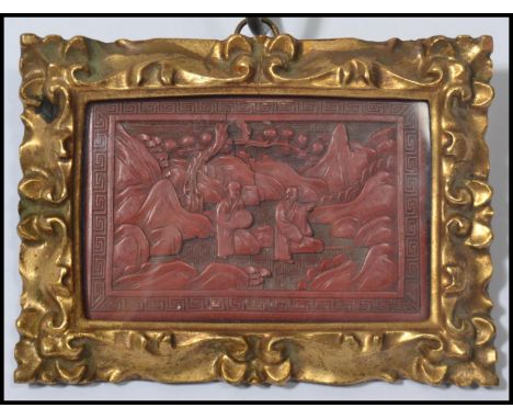 A 19th century Chinese Cinnabar lacquer picture having a Greek key border. The central panel depicting scenes of elders with 