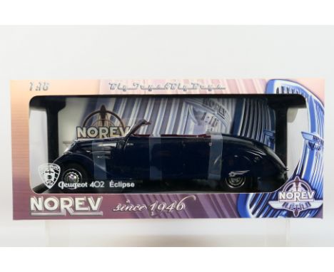 Norev - A boxed 1:18 scale Norev #184704 Peugeot 402 Eclipse. The model in blue appears to be in Mint condition, housed withi