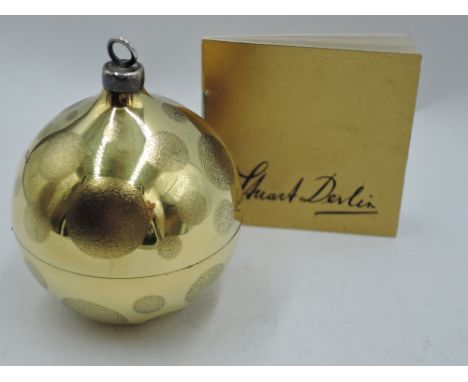 A Stuart Devlin 1981 silver gilt Christmas tree bauble having dot decoration and lift off cover revealing silver and enamelle