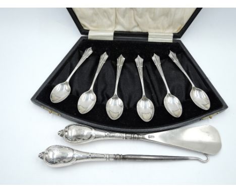 A cased set of six silver coffee spoons having moulded terminals, Birmingham 1923, W H Haseler Ltd, approx 40.8g and an HM si