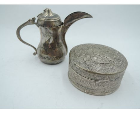 A Middle Eastern white metal Dallah coffee pot of small form bearing Arabic scenes to sides (AF) and a white metal lidded tri