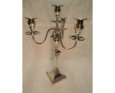 A large Edwardian silver four light candelabrum having a detachable top with trio of scroll branches and central light, all h