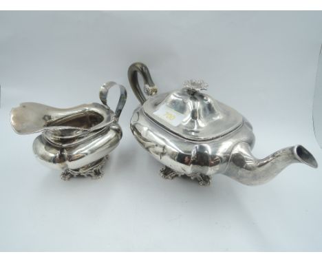 A Dutch silver bachelor teapot and cream jug having moulded bracket pedestal foot, flower finial and  loop handle, (AF) appro