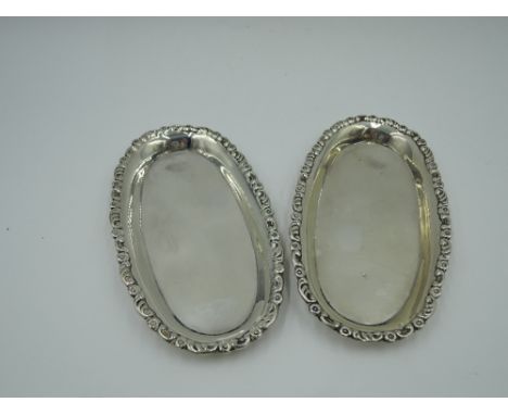 A pair of Edwardian silver trinket trays of oval form having moulded decoration to raised rim, London 1904, Mappin &amp; Webb