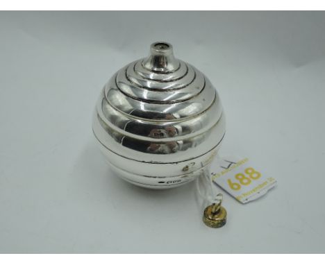A Stuart Devlin 1984 silver Christmas tree bauble having ridged decoration and lift off cover revealing silver and enamelled 