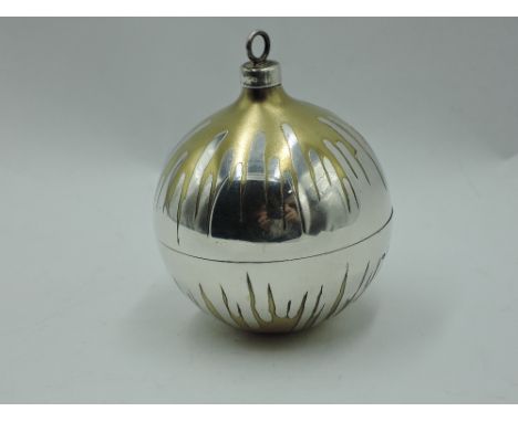 A Stuart Devlin 1982 silver  Christmas tree bauble having gilt decoration and lift off cover revealing silver and enamelled c
