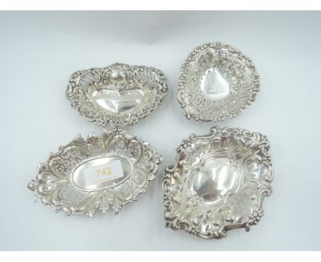Four HM silver trinket dishes of different shapes, all having pierced and repousse decoration, approx 77g