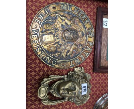 A brass door knocker modelled as a Classical Head together with a brass circular Milners Patent fire resistant brass plaque
