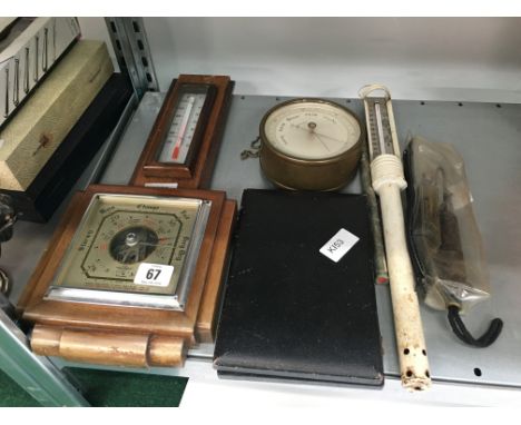 An oak cased Art Deco barometer together with a circular glassed cased compensated baromter and other items.