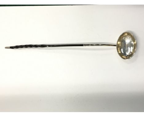 A silver ladle with turned whalebone handle.