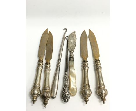 A collection of French silver handled knives, mother of pearl handled butter knife, button hook etc.