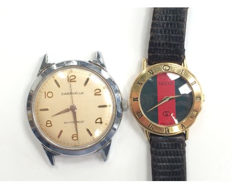 A gentleman's stainless steel Caravelle manual wind wristwatch head together with a ladies gold coloured Gucci Quartz wristwa