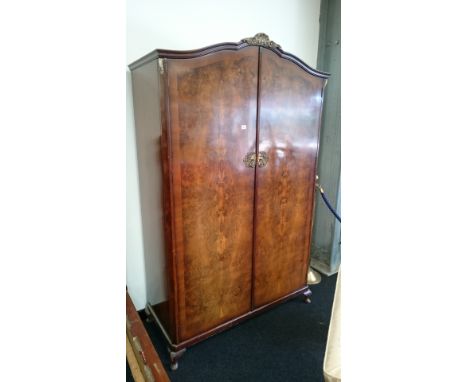 A large two door walnut veneered ladies wardrobe with interior brass hanging rails and top shelf, matching previous lot 25. 