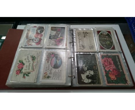 A postcard album containing a collection of Chromolithographic postcards including Little Tommy, Oilettes, First World War Bi