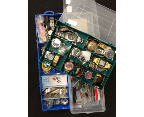 Two boxes containing various wristwatches together with watch tools.

