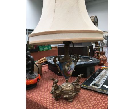 A French Sevres design table lamp decorated with a panel in blue of a young girl with a fan, the gilt metal base decorated wi