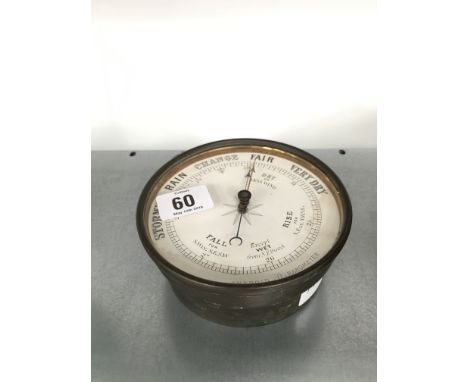 A circular brass cased aneroid barometer.