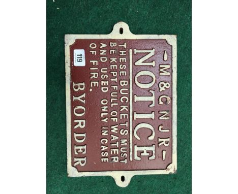 An M & C N J R railway sign in red and cream "These buckets must be kept full of water and used only in case of a fire by ord