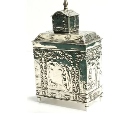 A Dutch silver tea caddy decorated with rural scenes.